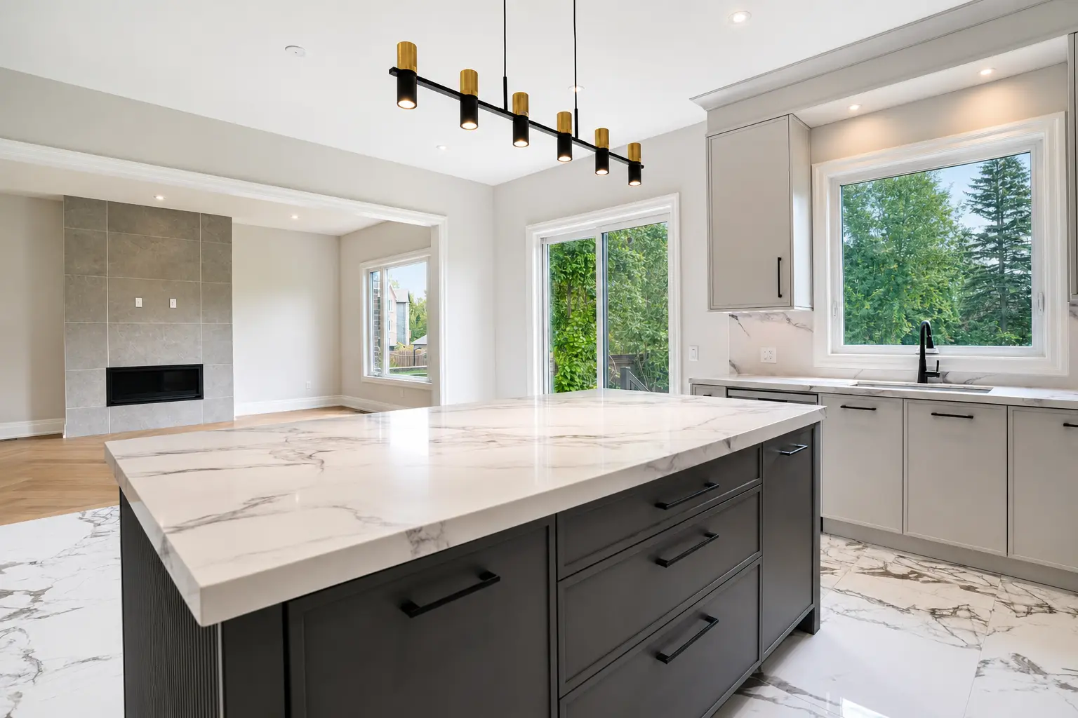 Kitchen island looking through to the tiled fireplace and garden windows