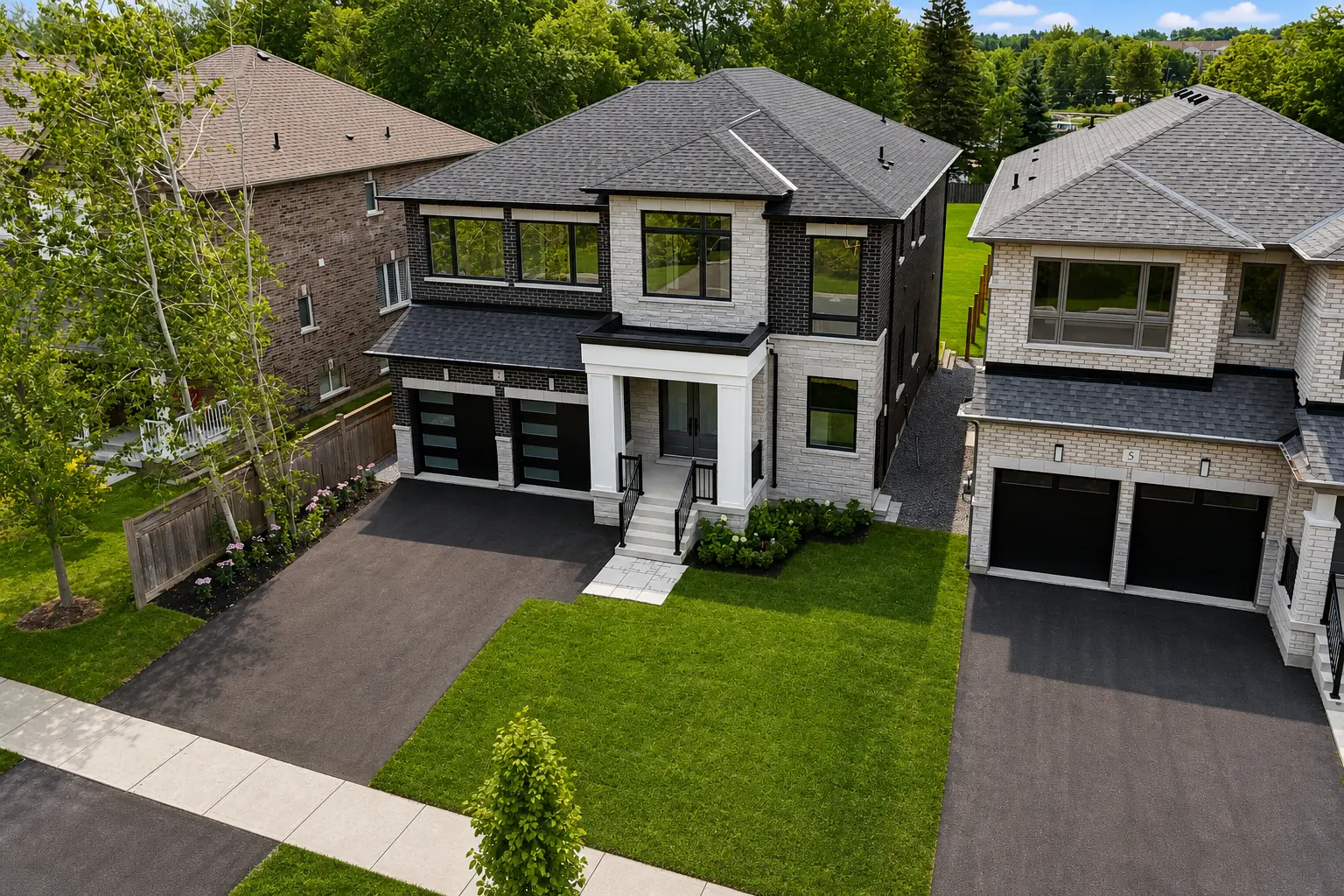 Aerial view of the home's front elevation and driveway