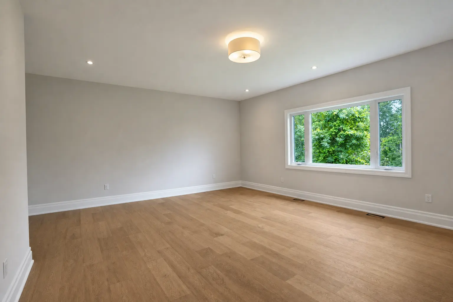 Primary bedroom with wide-plank oak floors and treed outlook