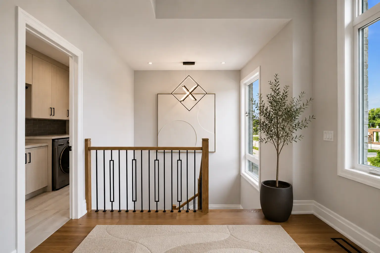 Upper hall landing with iron spindle railing beside the laundry room