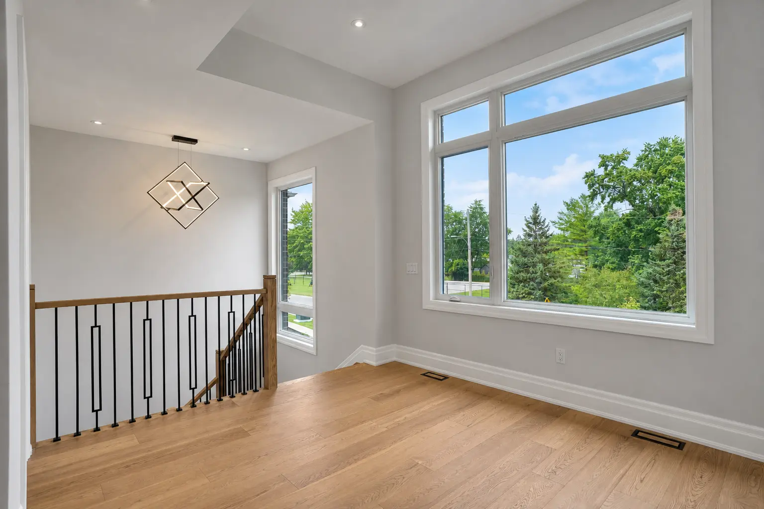 Upper landing sitting nook with oversized window and pendant