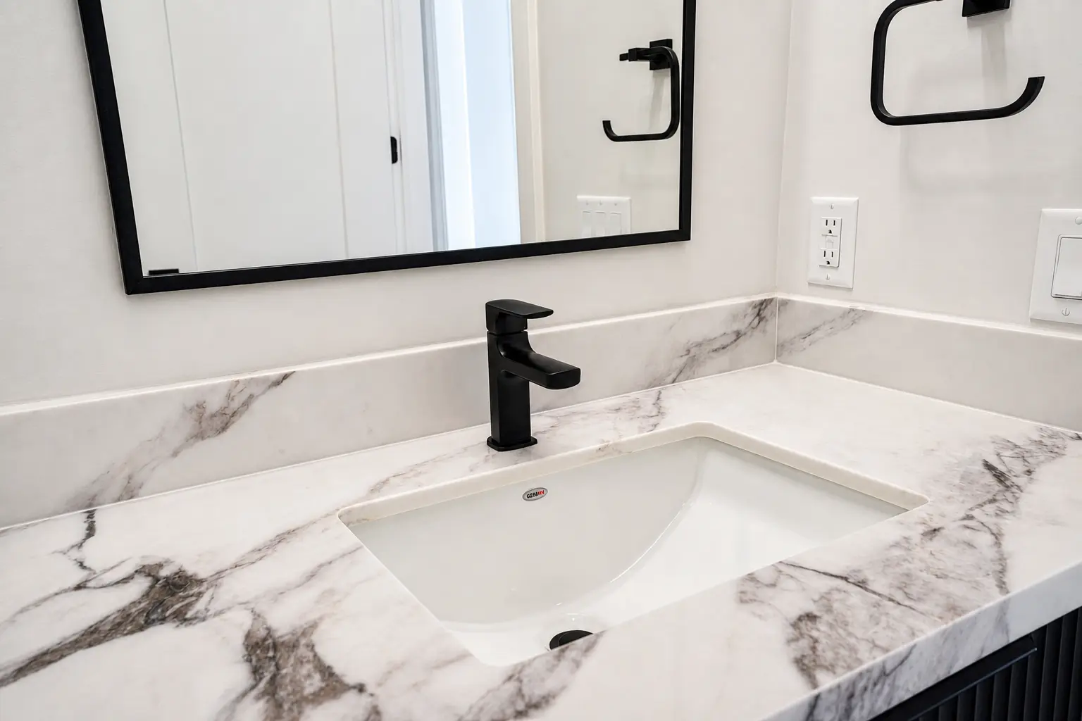Close-up of the marble vanity top with undermount sink and matte black tap