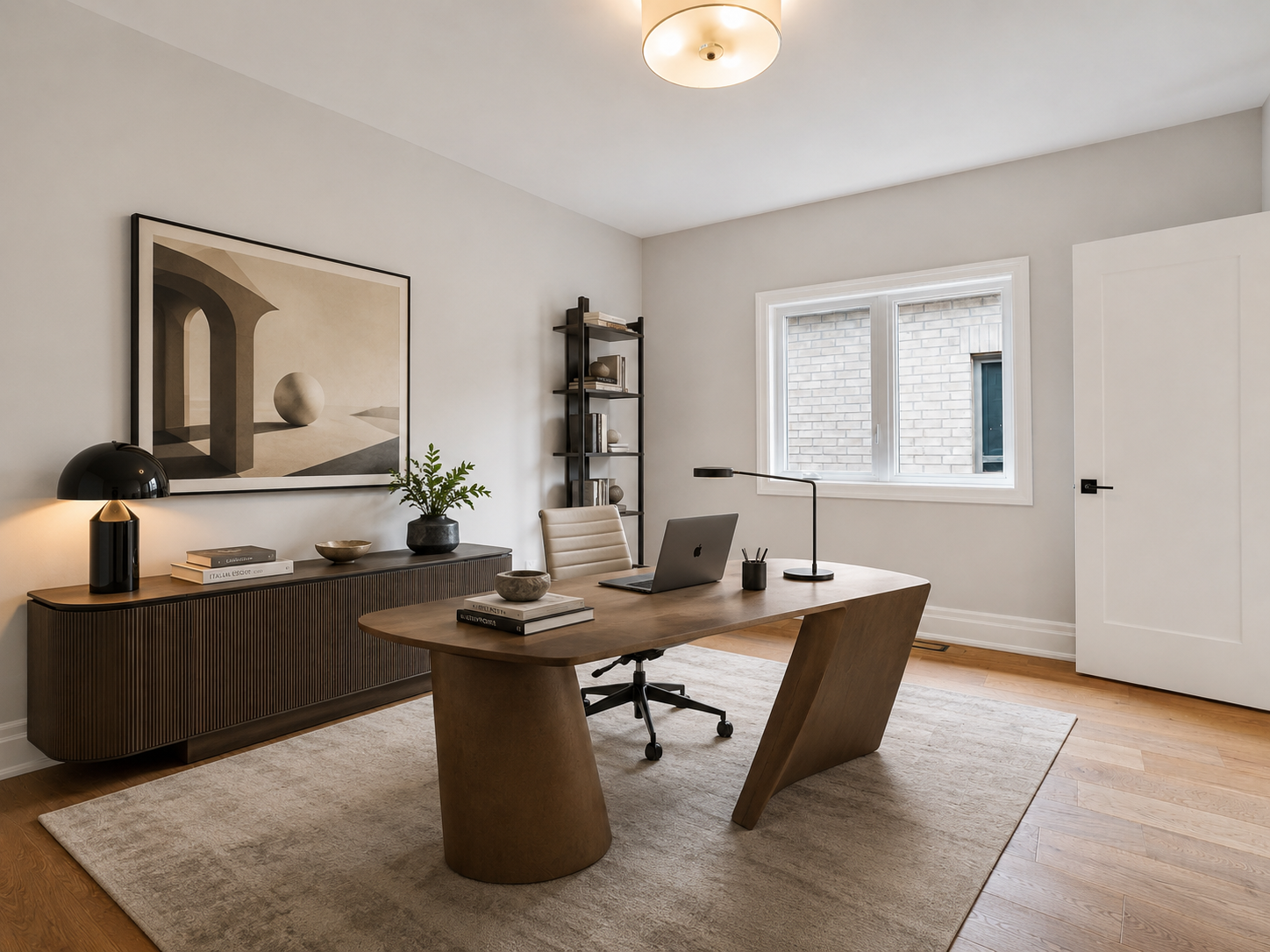 Home office with sculptural walnut desk, fluted credenza and framed art